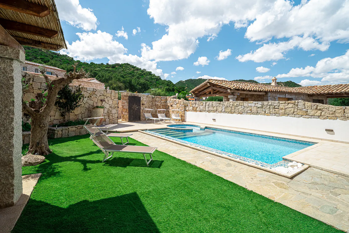 Sun loungers and lawn along the pool