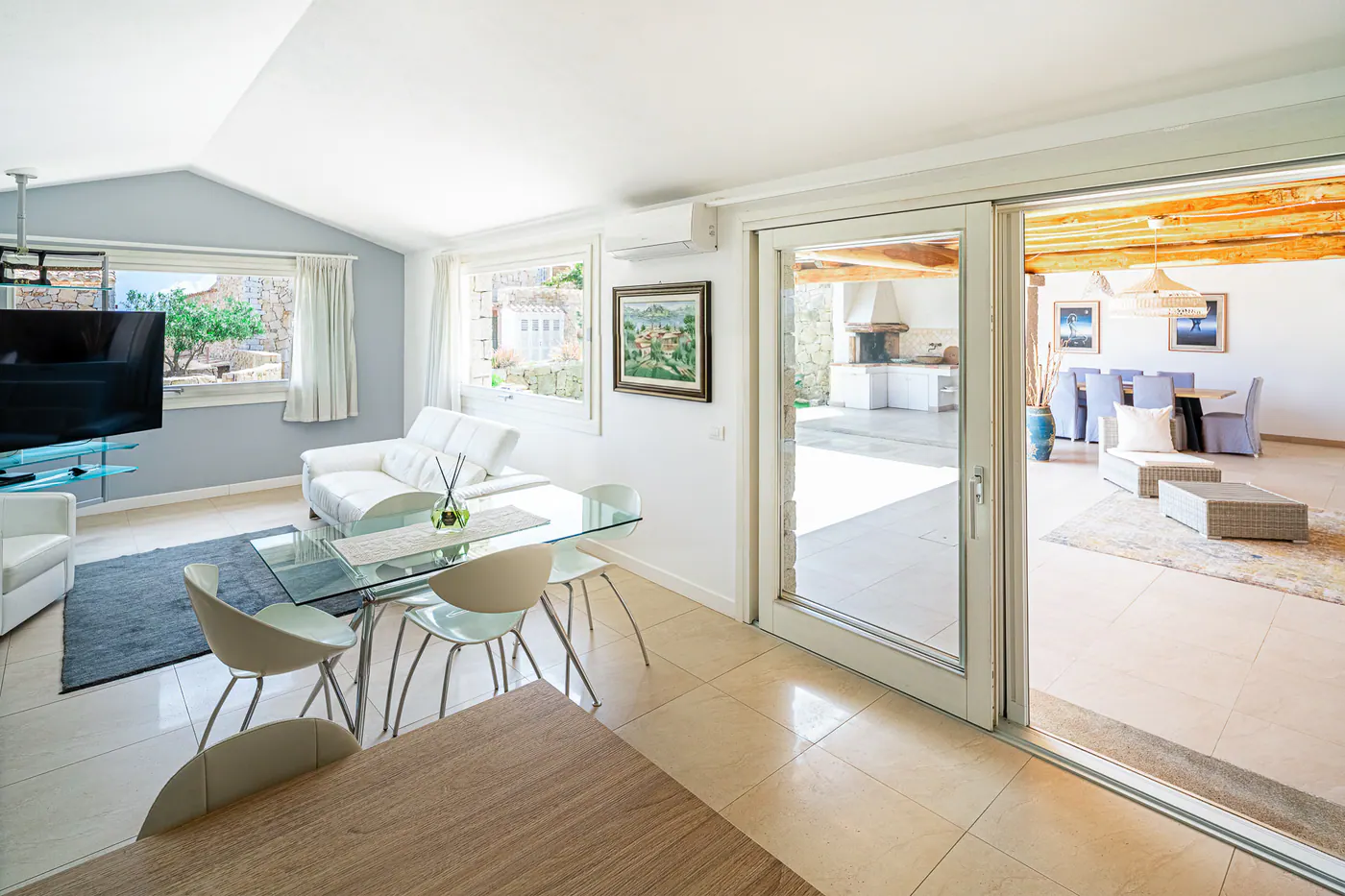 The living room with the sliding glass door open onto the covered patio